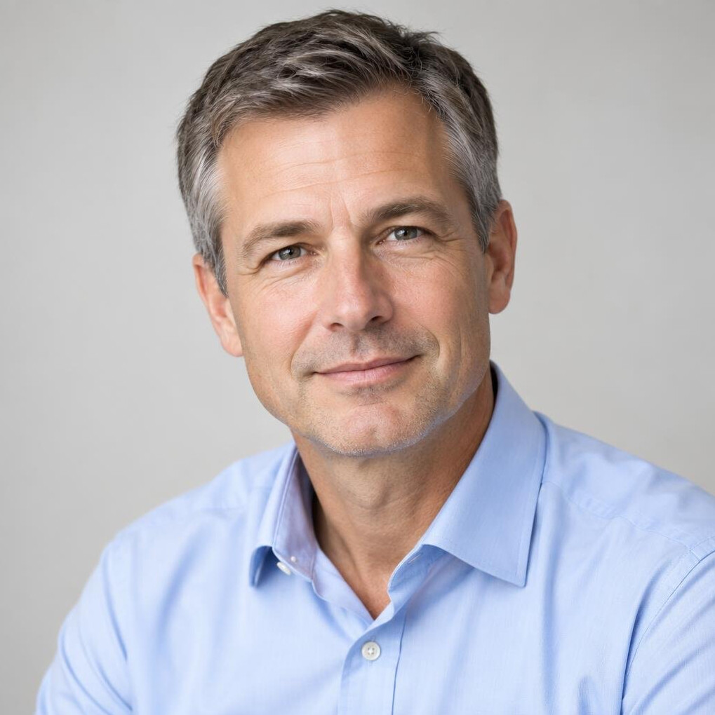Portrait of a man in a light shirt looking at the camera