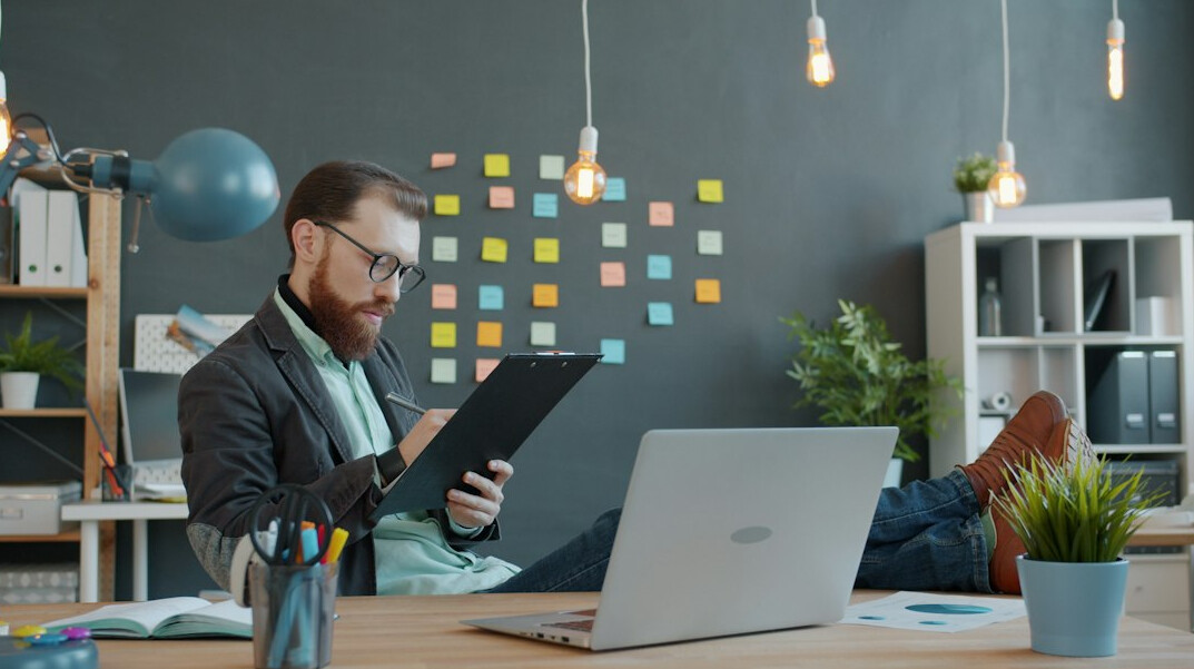 man reading book in office